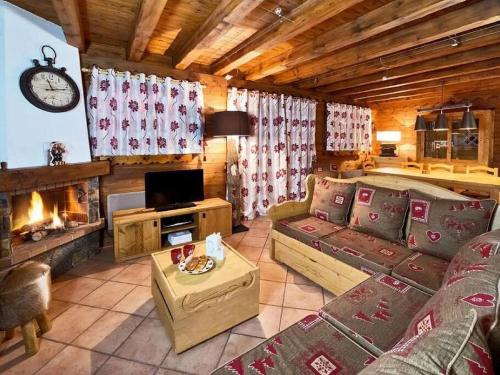 a living room with a couch and a fireplace at Meribel Les Allues Ski Chalet with beautiful views in Les Allues