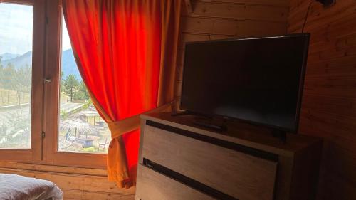 a flat screen tv in a bedroom with a window at BioFarm Gramsh 