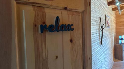 a wooden garage door with the rakes sign on it at BioFarm Gramsh in Kodovjat