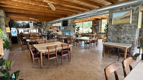 a dining room with tables and chairs in a restaurant at BioFarm Gramsh 