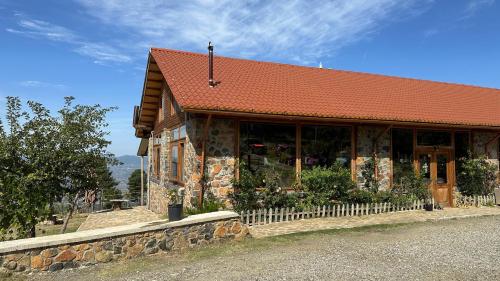 a building with a red roof on top of it at BioFarm Gramsh in Kodovjat