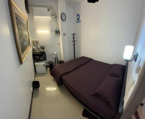Ban Don Muang (1)にあるDonMueang station hostelのベッドと壁に時計が備わる病室です。