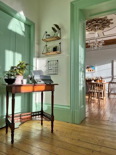 a room with a table with a phone on it at Coed Mawr Hall Bed & Breakfast in Conwy