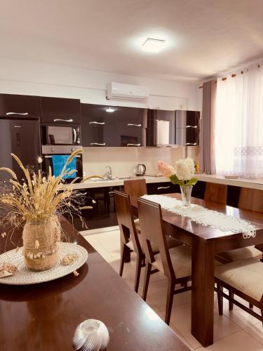 a kitchen and dining room with a table and chairs at Villa Merkuri in Himare