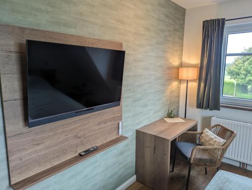 a room with a large flat screen tv on a wall at PaGa - Parkgaststaette in Ehrenburg