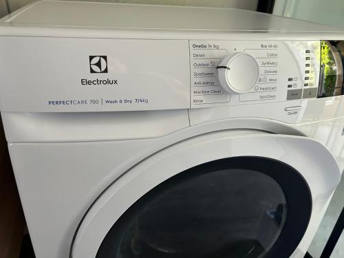 a white washing machine with a white door at APARTMENT GAL in Novo Mesto