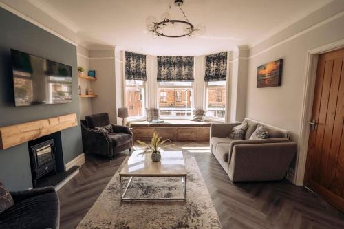 uma sala de estar com um sofá e uma lareira em The Dunes, Lytham St Annes em Lytham St Annes
