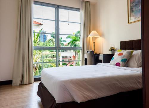 a bedroom with a bed and a large window at Diamond Westlake Suites in Hanoi