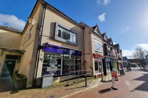 a building on a street with shops on it at One bedroom Apartment in the heart of Horsham city centre in Horsham