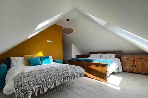 a bedroom with two beds in a attic at The Sails in East Wittering