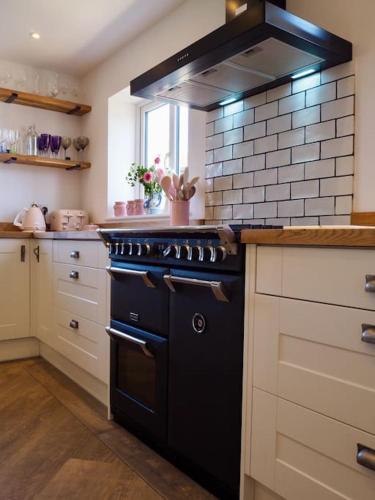 a kitchen with a black stove top oven at The Sails in East Wittering
