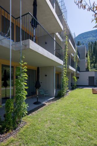 a large building with a lawn in front of it at Livingreen Residences in Feldkirch