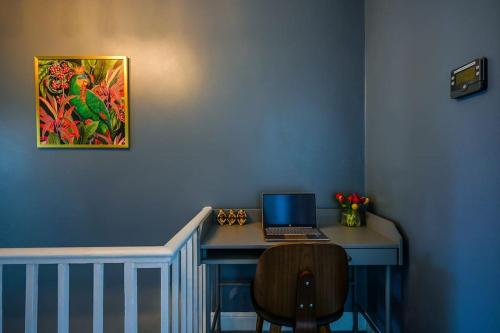 a desk with a laptop computer on top of it at Luxury Central City Centre Townhouse with Garden in Cardiff