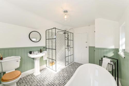 a bathroom with a shower and a toilet and a sink at Luxury Central City Centre Townhouse with Garden in Cardiff