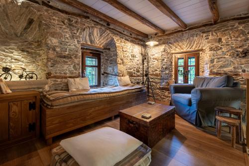 a living room with a stone wall at Mountain's Secret in Mouresi