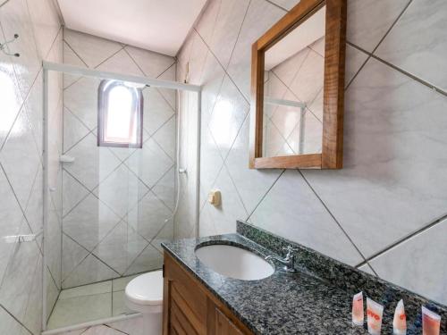 a bathroom with a sink and a shower at Pousada Sol e Praia in Torres