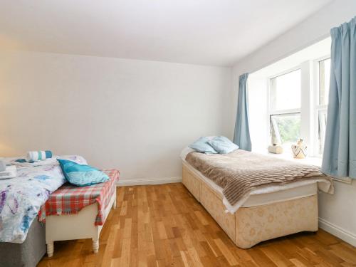 a bedroom with two beds and a window at Knightsward Farm in Anstruther