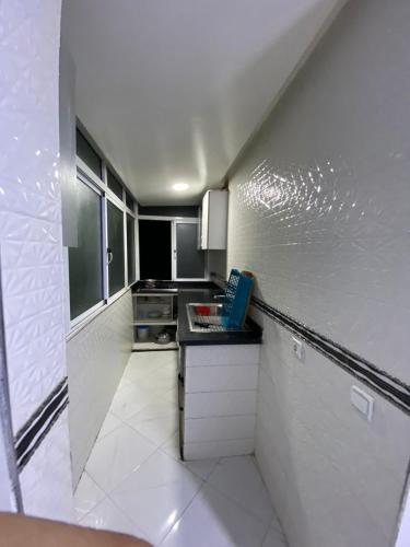 a small kitchen with a counter top in a room at Fatimaresi in Casablanca