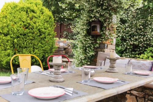 a wooden table with plates and glasses on it at Mountain's Secret in Mouresi