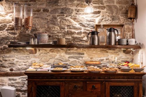 a buffet of food on a stone wall at Mountain's Secret in Mouresi