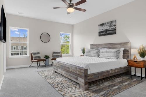 a bedroom with a bed and a ceiling fan at Luxurious 3 Story Townhome! The Dye at Barefoot Resort 402- Sleeps 12! in North Myrtle Beach