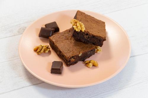 a plate with two pieces of brownies and chocolate at Comfort Aparthotel Lourdes L'Acacia in Lourdes