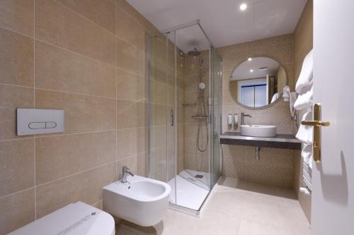 a bathroom with a toilet and a sink and a shower at Palazzo Santo Spirito in Bergamo