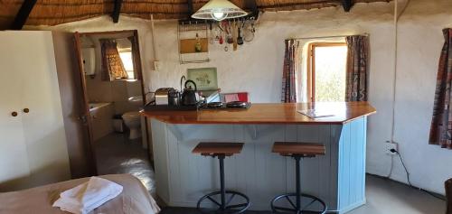 a kitchen with a island in a room at Mashai Rest Rondavel in Underberg