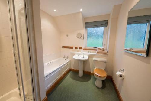 a bathroom with a sink and a toilet and a tub at The Keepers in Aberfeldy