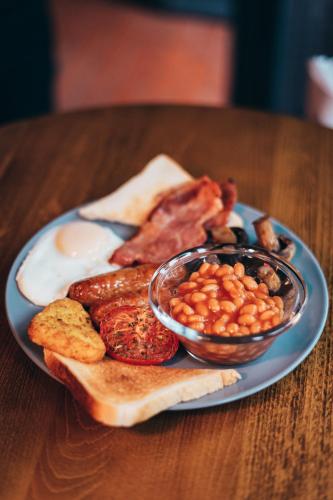 a plate of breakfast food with eggs bacon beans and toast at The Cock and Magpie in Bewdley
