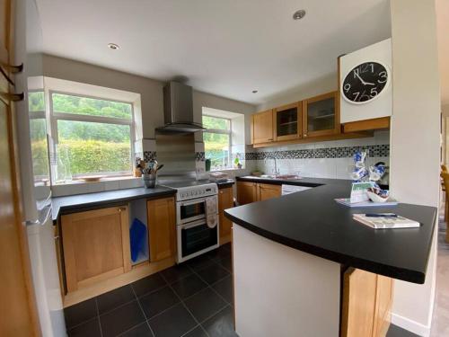 a kitchen with a black counter top and a window at Castle Kennels in Aberfeldy