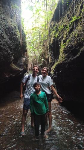 a group of people standing in the water in a cave at Bunga Maliq Bungalow Lombok in Tetebatu