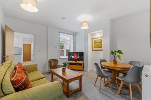 a living room with a couch and a table at Ground Floor Apartment with Courtyard in Loughborough
