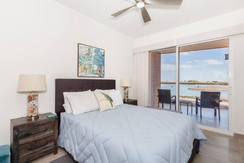 a bedroom with a bed and a view of the ocean at Eagle Village at Islas del Mar C7 in Puerto Peñasco