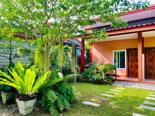 a house with a garden in front of it at Baan Longhaad in Ko Lanta