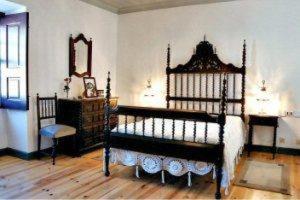 a room with a bed and a dresser and a mirror at Solar dos Caldeira e Bourbon in Zebras