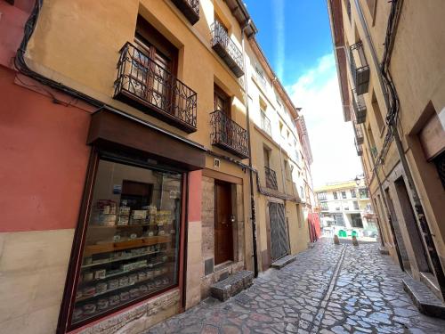 a street with a shop on the side of a building at Bermudo III Plaza Mayor de León in León