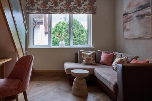 a living room with a couch and a window at Fairlawns, Hotel And Spa in Walsall