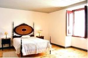 a bedroom with a large bed and a window at Solar dos Caldeira e Bourbon in Zebras