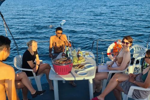a group of people sitting around a table on a boat at KUHNLE-TOURS GmbH Malchin in Malchin