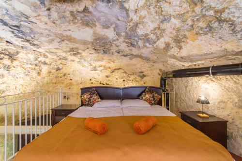 a bedroom with a large bed with a painting on the wall at Pleasant stone house & jacuzzi St Martin - Happy Rentals in Mġarr