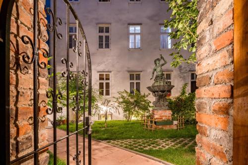 a gate with a statue in front of a building at Best Western Plus Celebrity Suites in Vienna