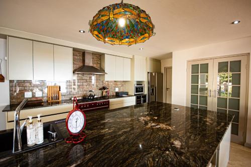 a kitchen with a counter with a clock on it at Walter’s Place in Jongensfontein