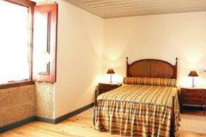 a bedroom with a bed and a window at Solar dos Caldeira e Bourbon in Zebras