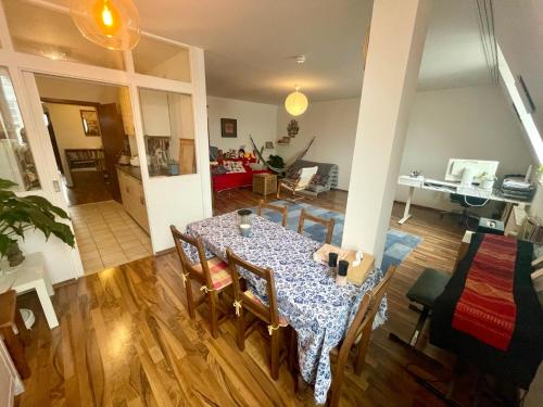 a dining table and chairs in a living room at Quiet room in big shared-flat 500m from Oktoberfest in Munich