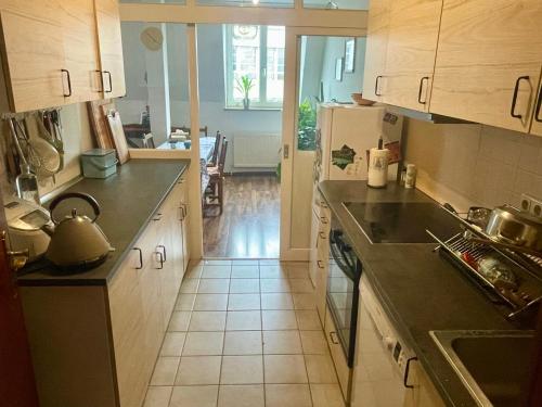 a kitchen with a sink and a stove at Quiet room in big shared-flat 500m from Oktoberfest in Munich