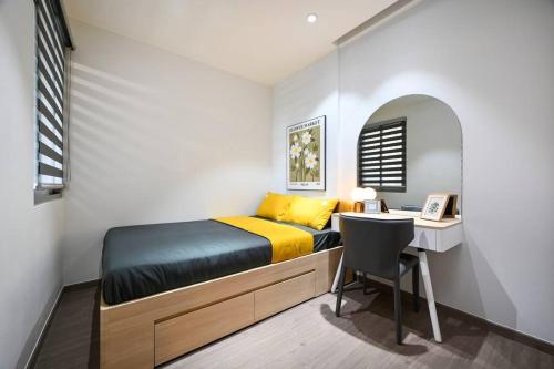 a small bedroom with a bed and a desk at Căn hộ Westgate- 2N House in Ho Chi Minh City