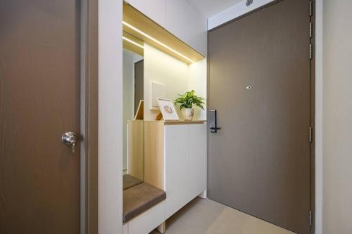 a hallway with a stair case and a mirror at Căn hộ Westgate- 2N House in Ho Chi Minh City