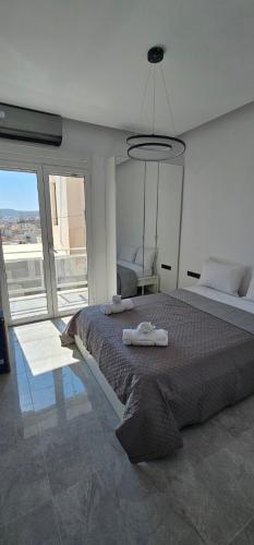 a bedroom with a large bed with towels on it at Infinity sea view in Lavrio