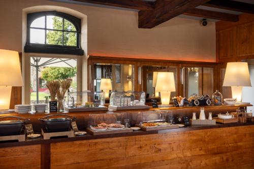 a buffet in a room with food on display at Hôtel & Spa de La Bretesche in Missillac